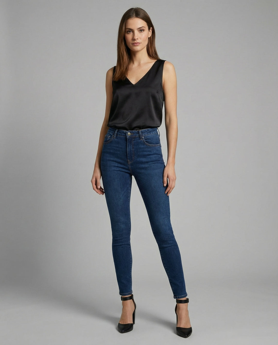 Female modelling a lightweight sleeveless silk top on a plain background.