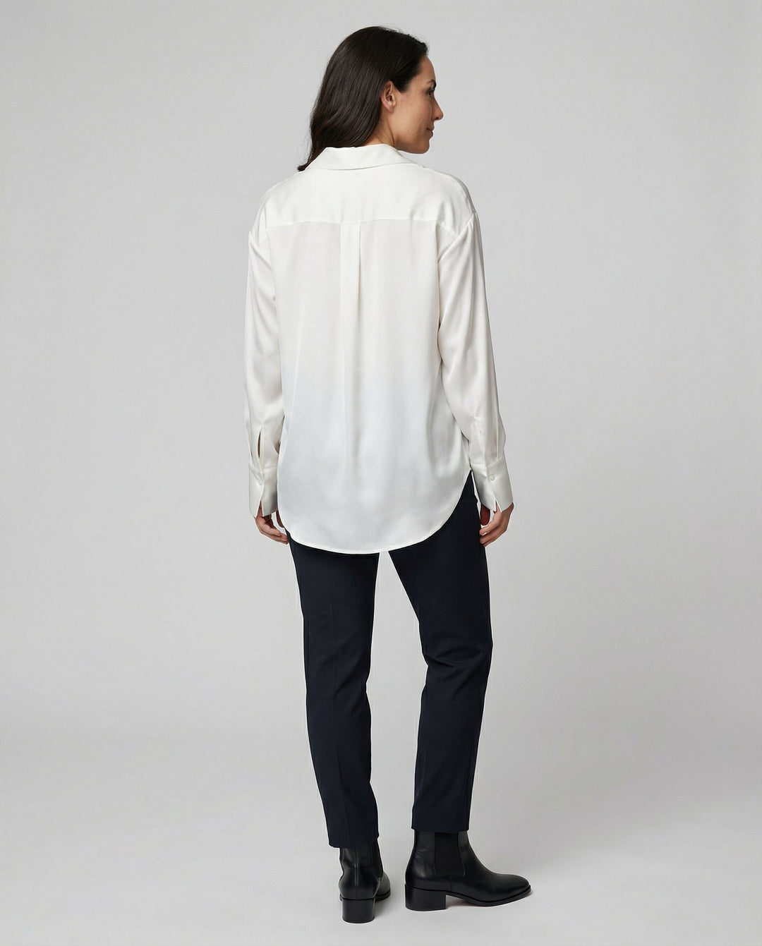 Female wearing a smooth silk blouse with a relaxed elegant fit.