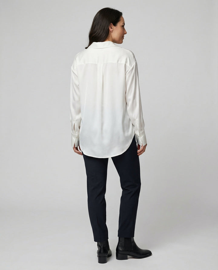Female wearing a smooth silk blouse with a relaxed elegant fit.