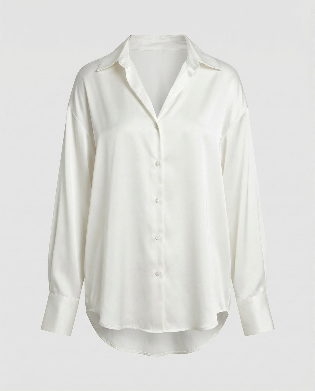 Woman in a long sleeve silk blouse styled on a plain background.
