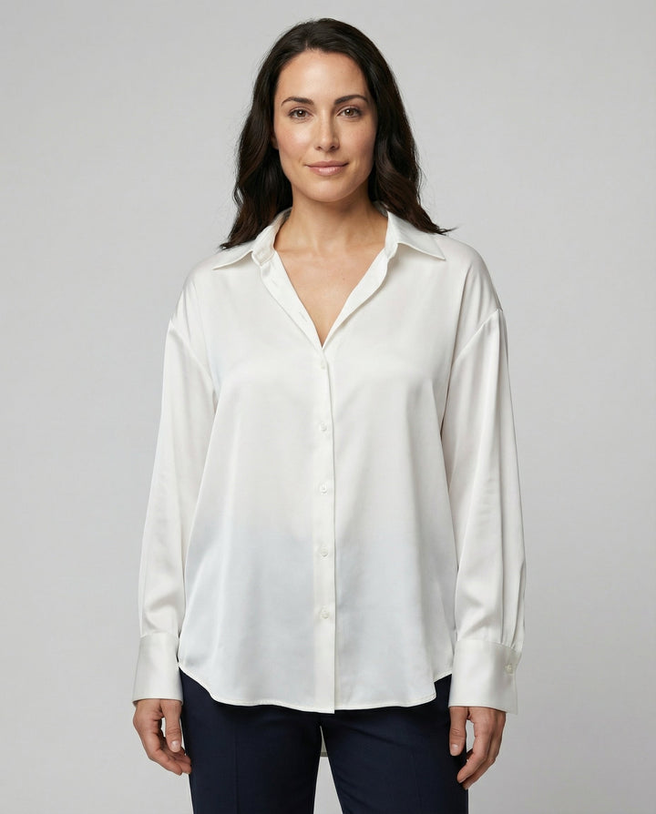 Woman wearing a lightweight silk blouse against a plain background.