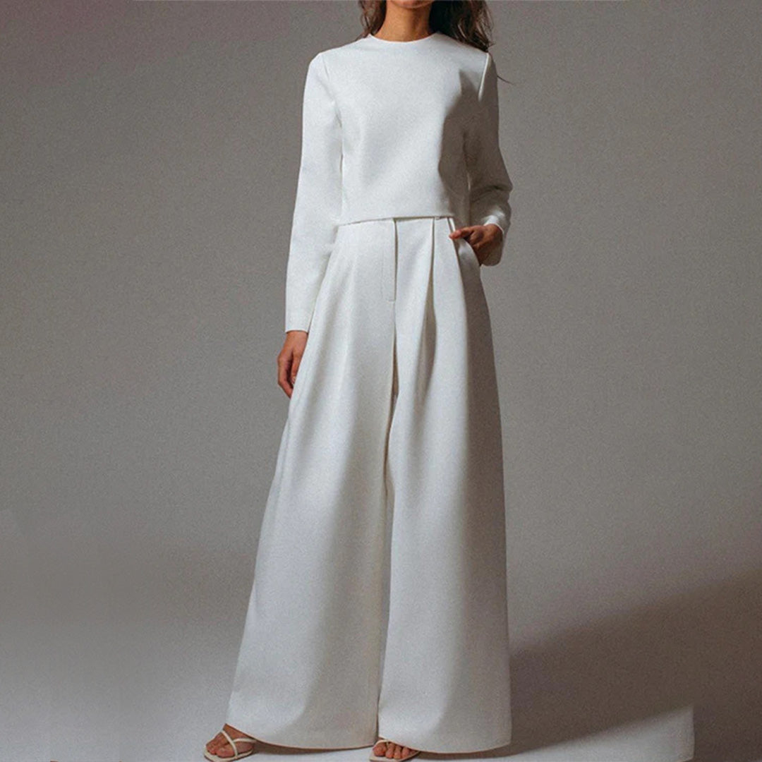 Woman modelling a casual outfit with high-waisted wide-leg trousers.
