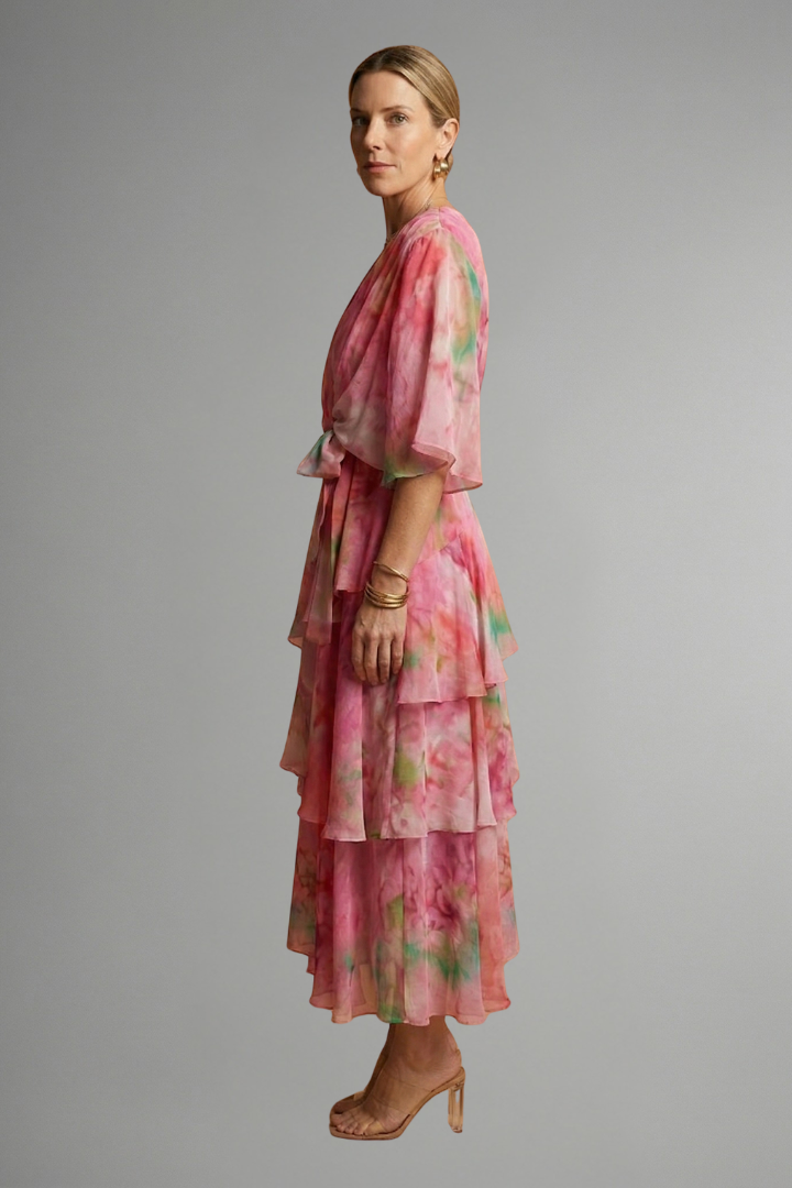Female model showcasing a sleeveless printed midi dress with a fitted waist and flared skirt.