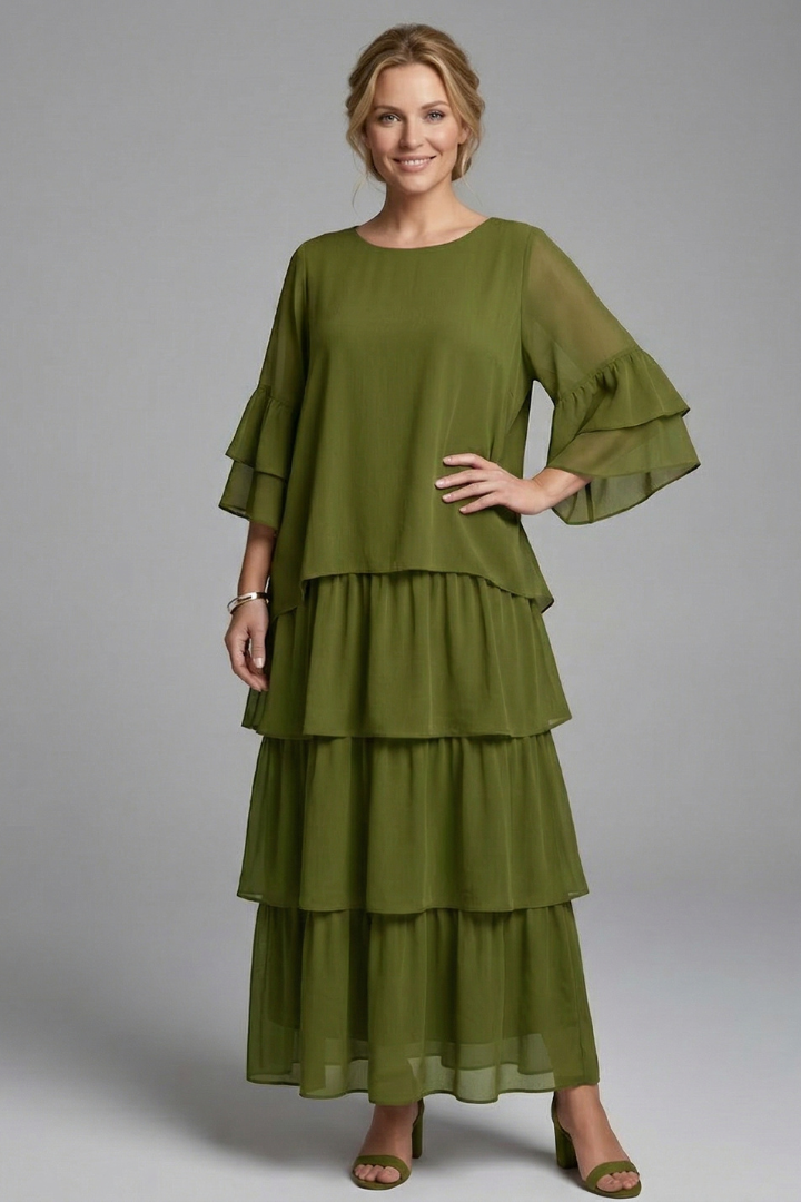 Female model showing a relaxed waist maxi dress with wide sleeves on a plain background.