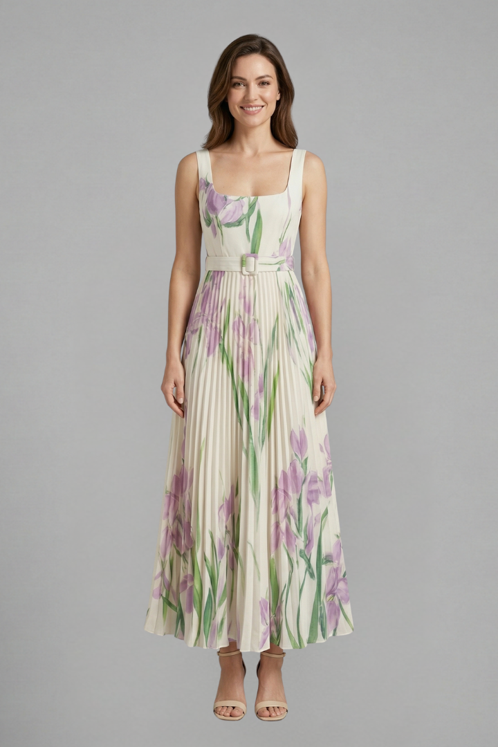 Female model wearing a floral maxi dress with a square neckline and pleated skirt against a plain background.