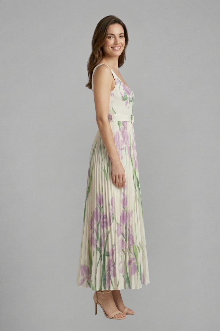 Woman in a sleeveless floral maxi dress with a fitted waist and flowing pleated design on a plain background.