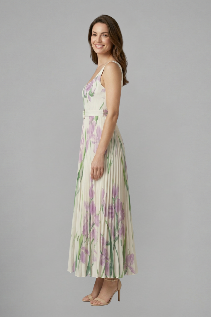 Female model showcasing a square neck maxi dress with floral print and full-length pleated skirt.