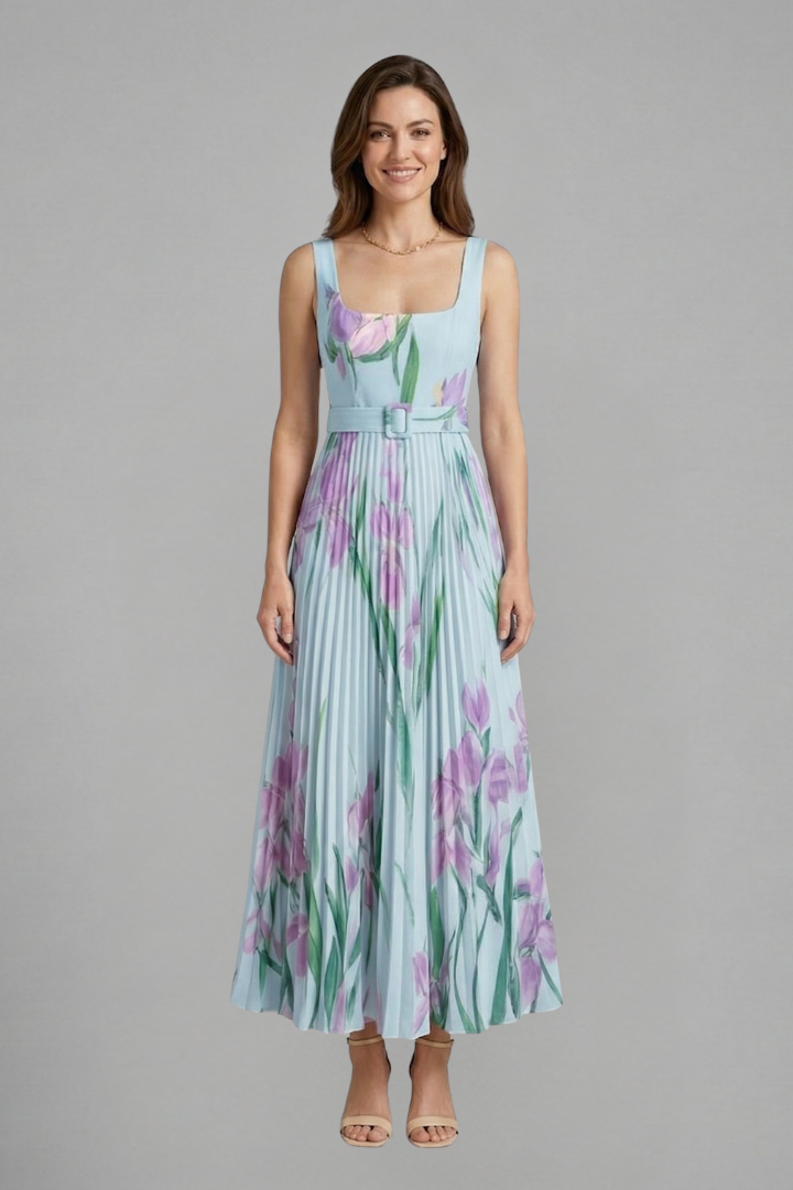 Female model showcasing a floral maxi dress with vertical pleats and square neckline styling.