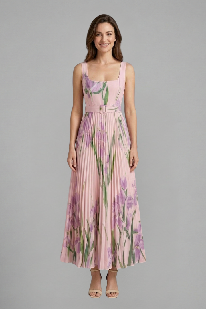 Female model wearing a square neck floral dress with pleated detailing throughout the skirt.