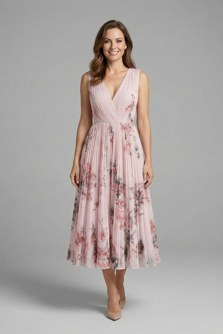Female model wearing a sleeveless V-neck midi dress with a pleated skirt against a plain background.
