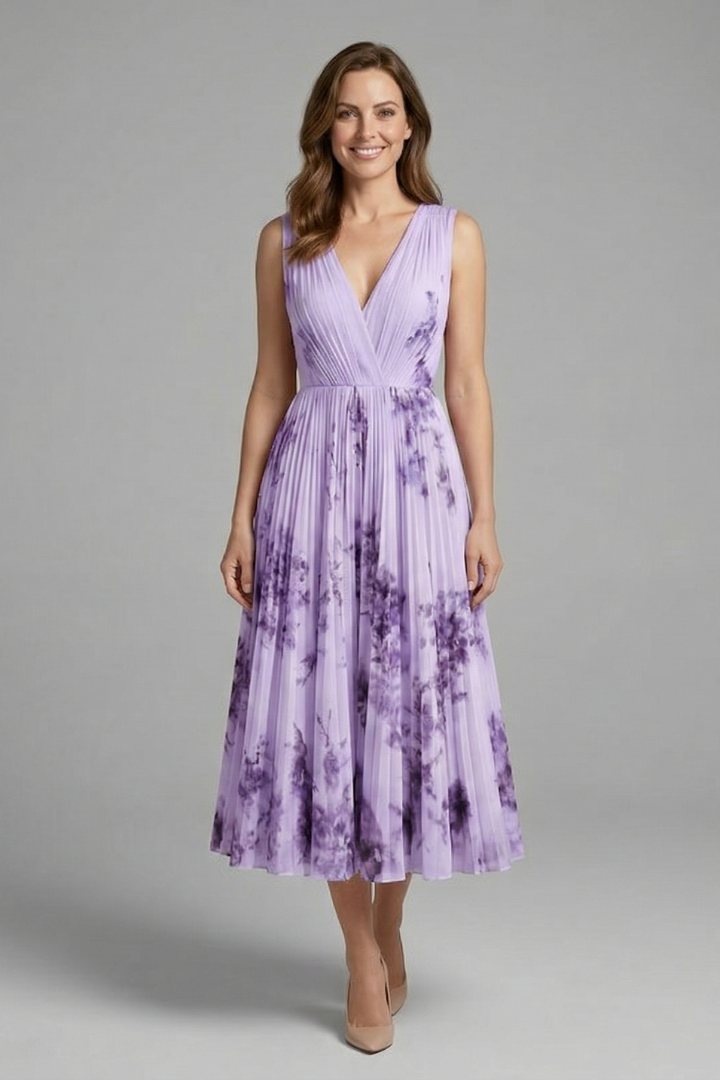 Woman in a V-neck midi dress featuring an all-over print and pleated detailing.