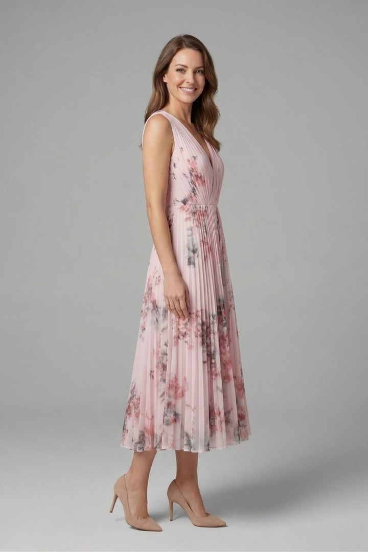 Female model showcasing a sleeveless midi dress with a fitted waist and all-over print.