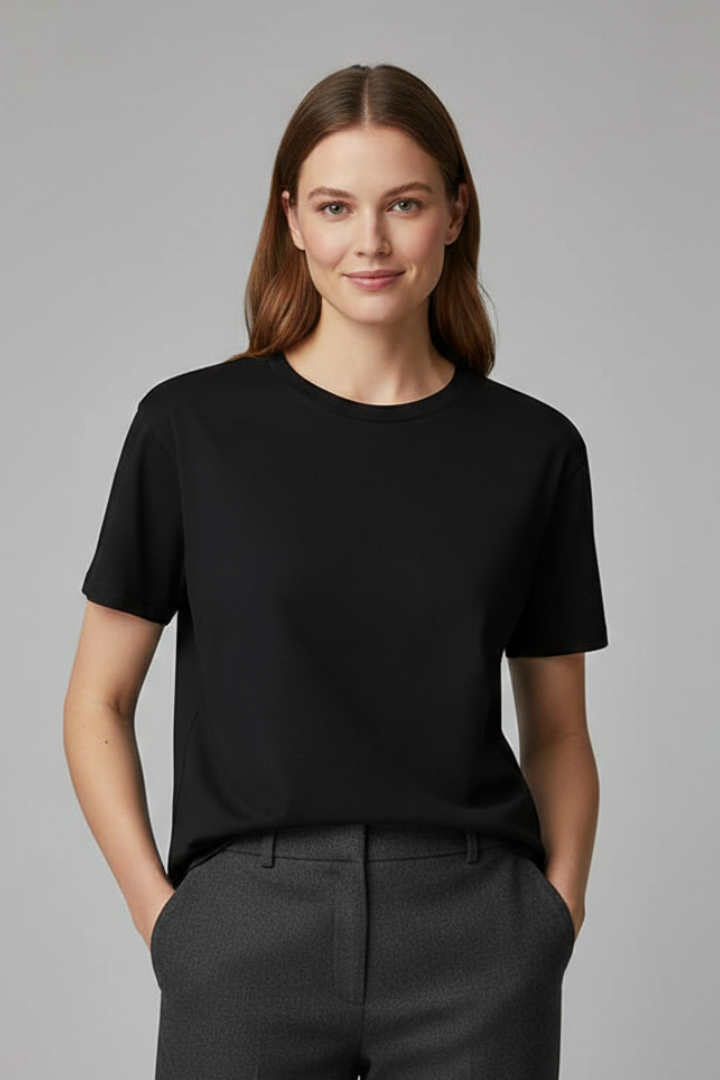 Oversized women’s T-shirt with round neckline and short sleeves on a plain background.