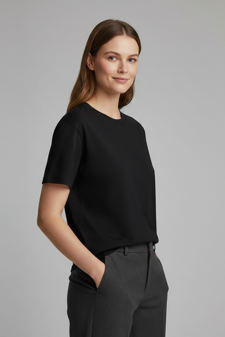 Women’s oversized short sleeve tee with straight hem on a plain background.