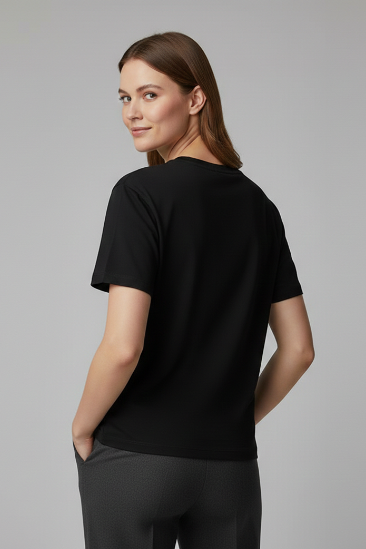 Casual women’s roomy T-shirt with simple round neck on a plain background.
