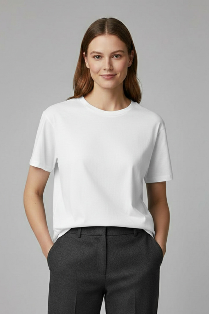 Relaxed women’s T-shirt with round neckline and straight hem on a plain background.