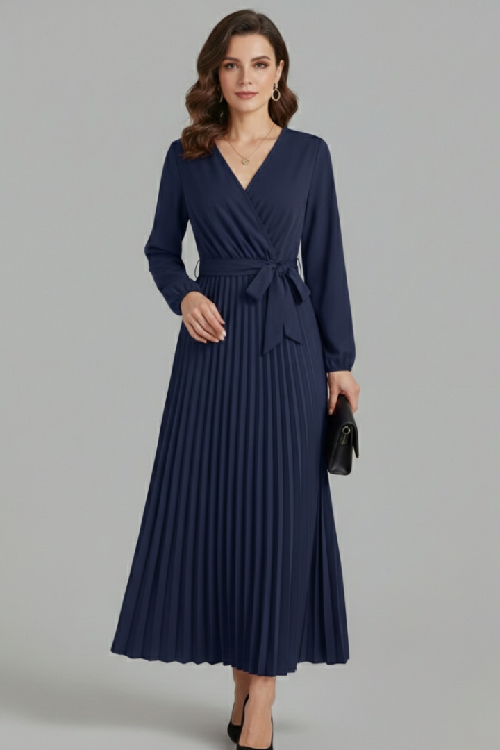 Female model in a V-neck maxi dress with long puff sleeves against a plain background.
