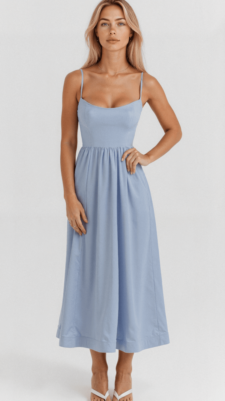 Woman in a relaxed fit midi dress with delicate shoulder straps.