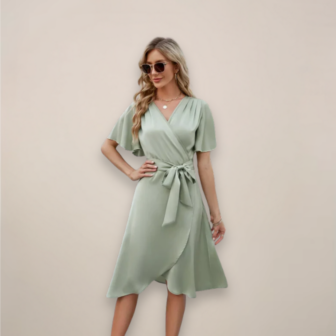 Female wearing a wrap-style midi dress with a relaxed drape.