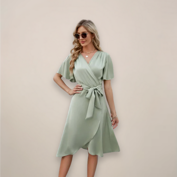 Female wearing a wrap-style midi dress with a relaxed drape.