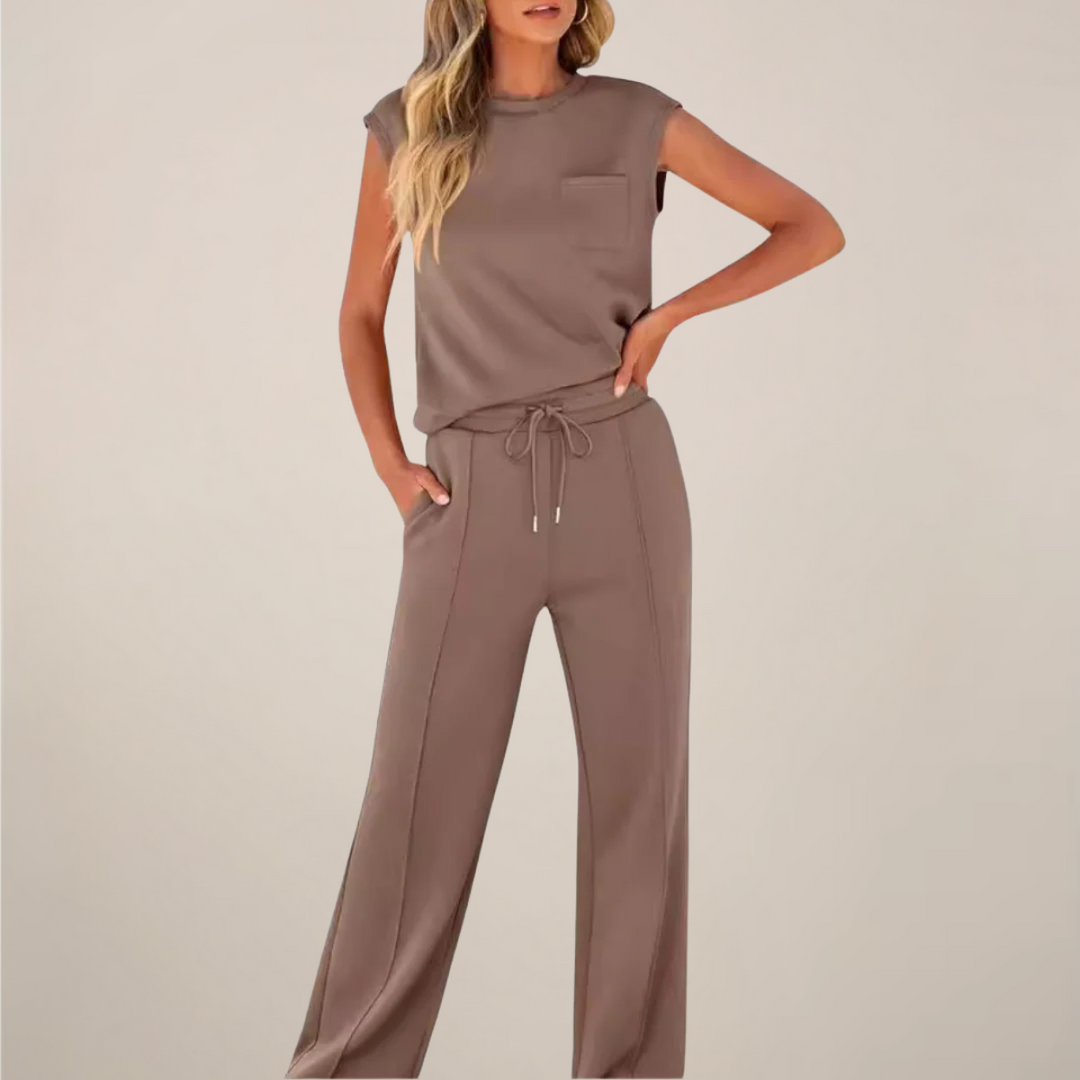 Female model wearing a coordinated top and straight-leg pants on a plain background.