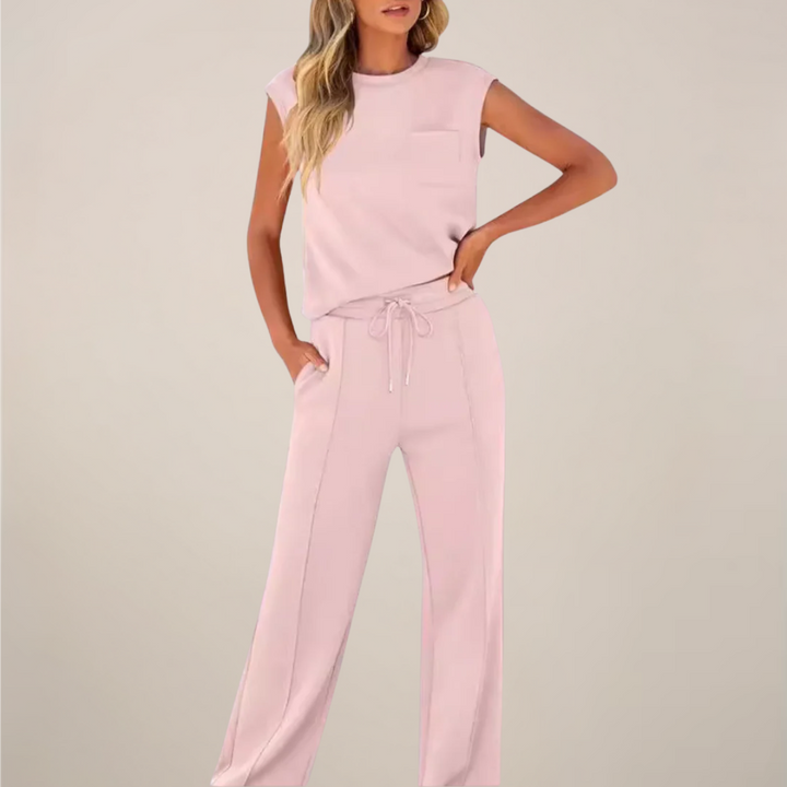 Model wearing a drawstring waist pants set with a clean casual look on a plain background.
