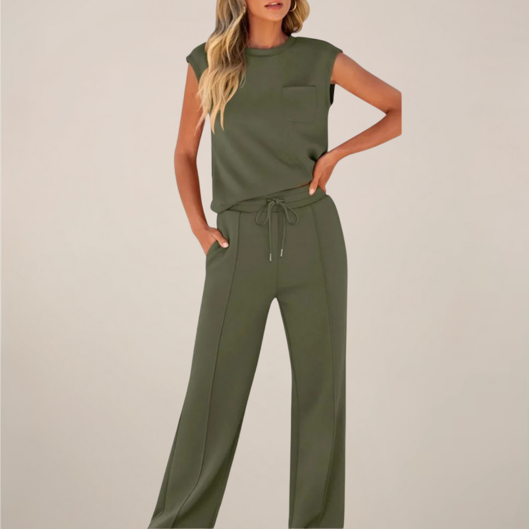 Female model in a loose top and straight-leg pants set on a plain background.