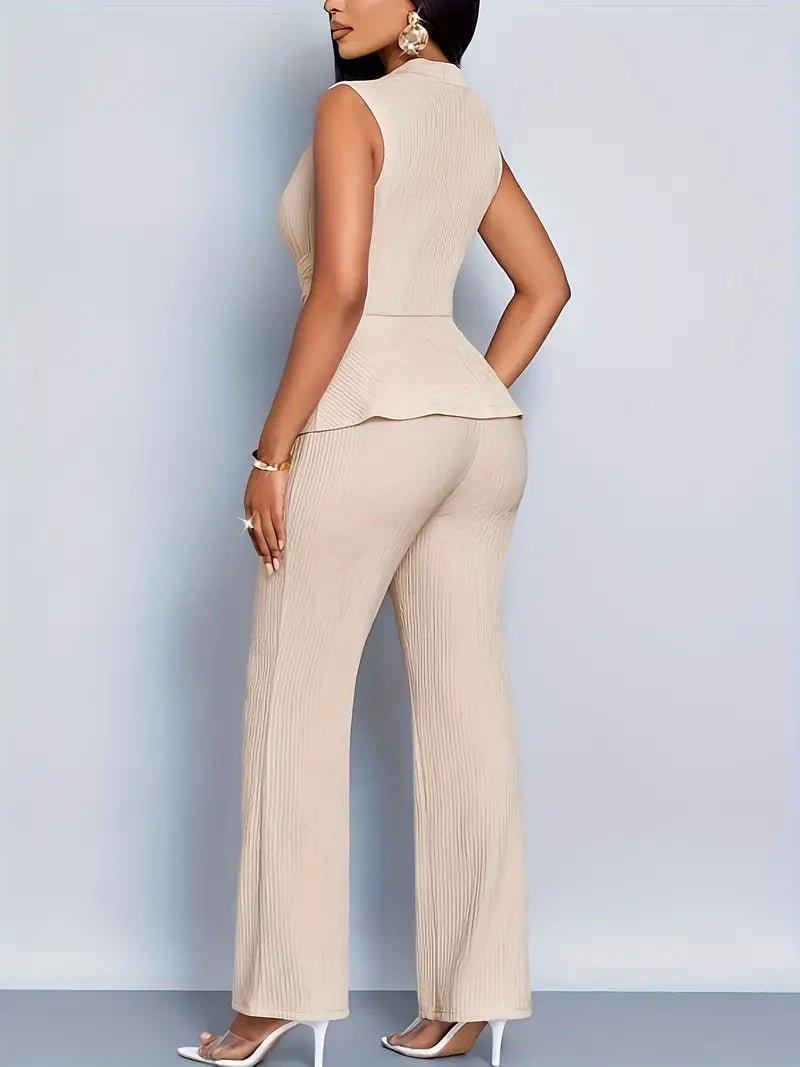 Female model in a defined-waist top and relaxed trousers against a plain background.