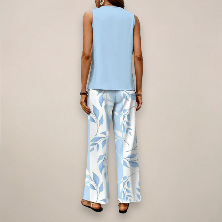 Model wearing a relaxed printed top and wide leg pants set on a plain background.