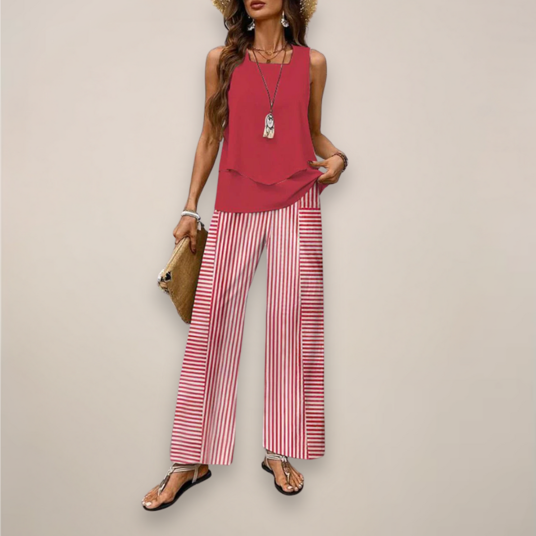 Female model in a coordinated summer two piece outfit on a plain background.