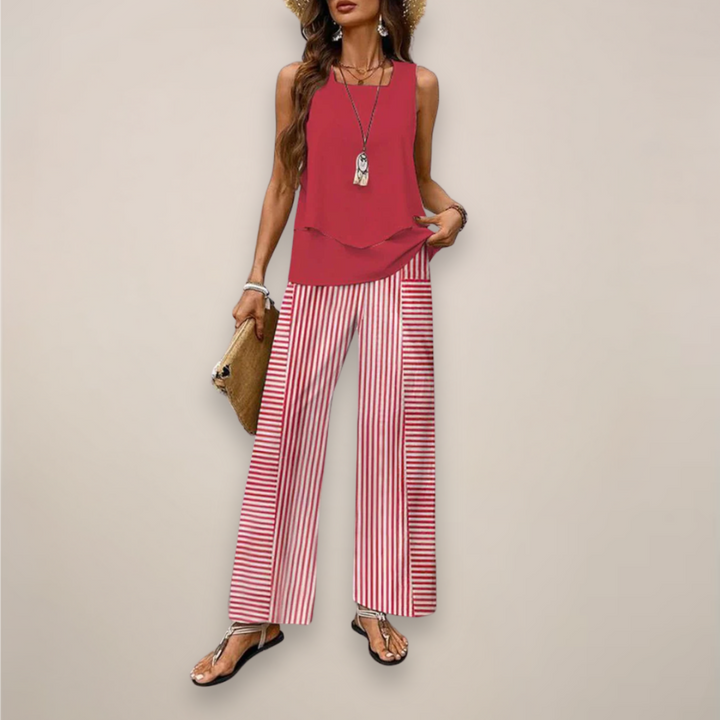 Female model in a coordinated summer two piece outfit on a plain background.