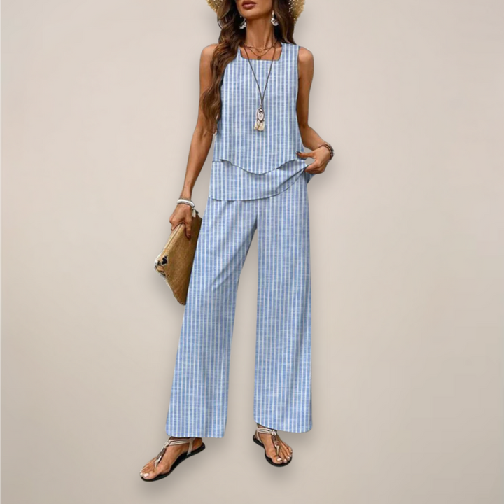 Model in a light printed matching set with relaxed pants on a plain background.