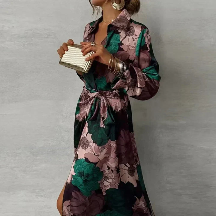 Female model wearing a dark green floral maxi shirt dress with long sleeves on a plain background.