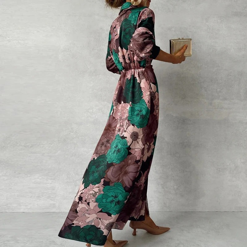 Female model showcasing a dark green long sleeve floral maxi dress with flowing skirt on a plain background.