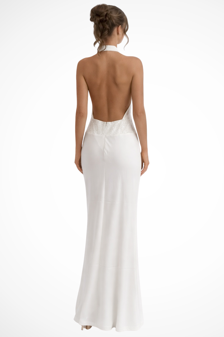 Female model in a formal maxi dress with soft draped front on a plain background.