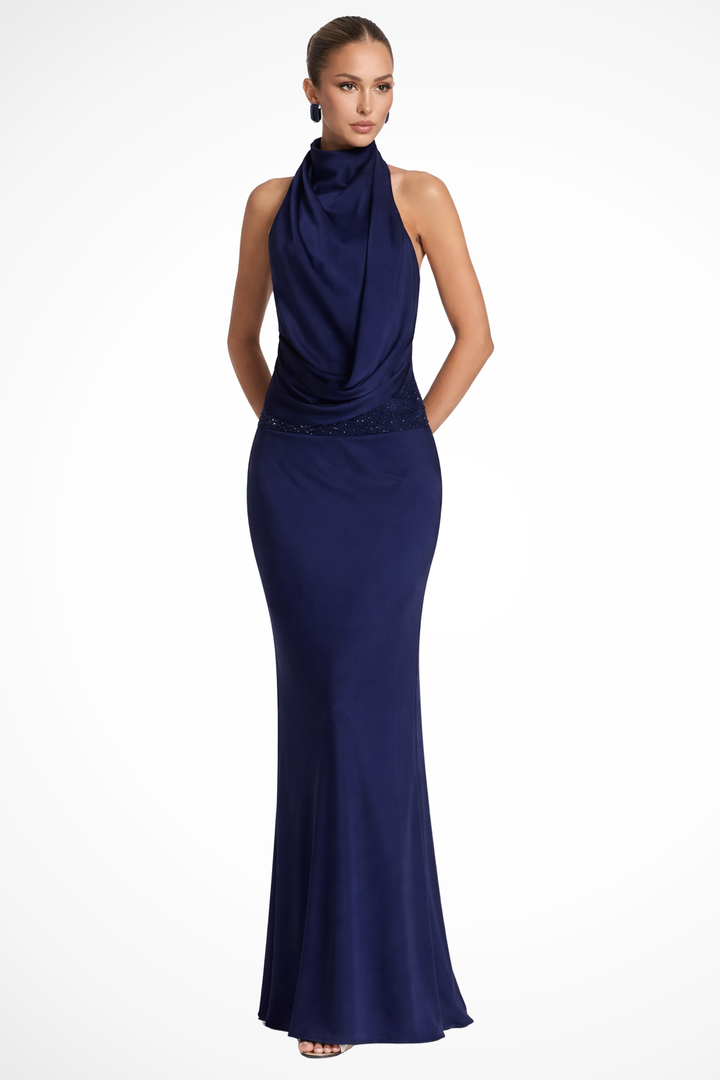 Female model wearing a satin maxi dress with halter neckline on a plain background.