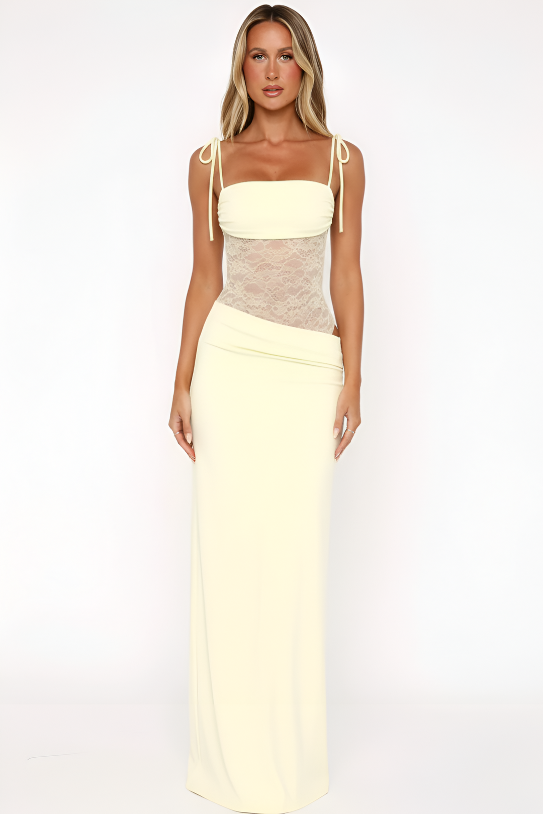 Model posing in a sleeveless maxi dress with flowing silhouette on a plain background.