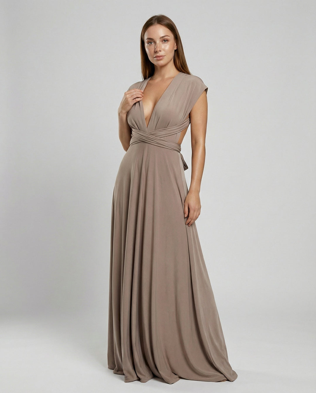 Female wearing a long multiway wrap maxi dress on a plain background.