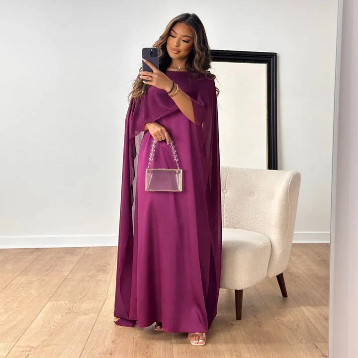 Model wearing a satin maxi dress for formal occasions on a plain background.
