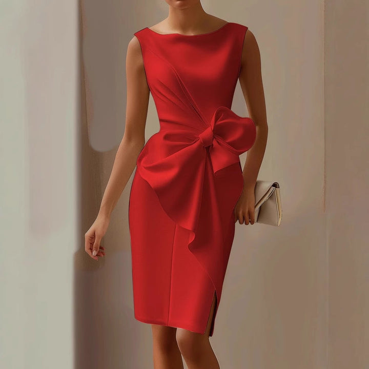 Model in an elegant midi dress with a boat neckline and oversized waist bow on a plain background.