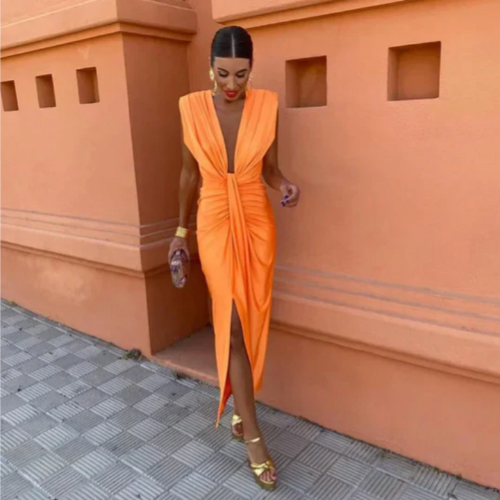 Model wearing a sleeveless full-length dress with gathered bodice on a plain background.
