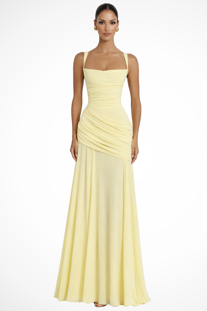 Female wearing a square neck maxi dress with ruched bodice on a plain background.