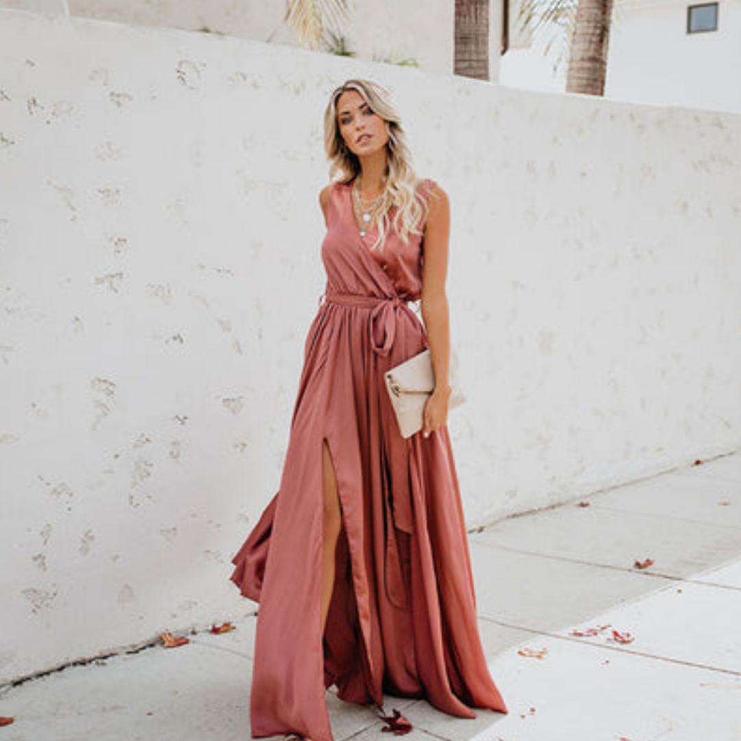 Female wearing a sleeveless tie-waist maxi dress on a plain background.