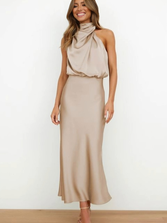 Female model showcasing a versatile flowing outfit on a plain background.