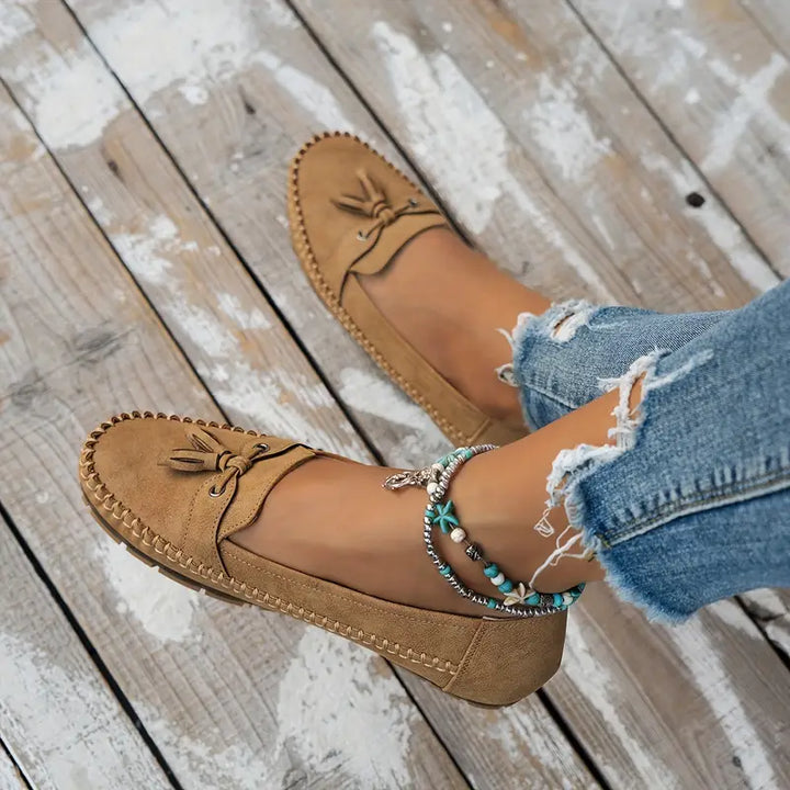 Classic slip-on shoes for women displayed on a plain background.