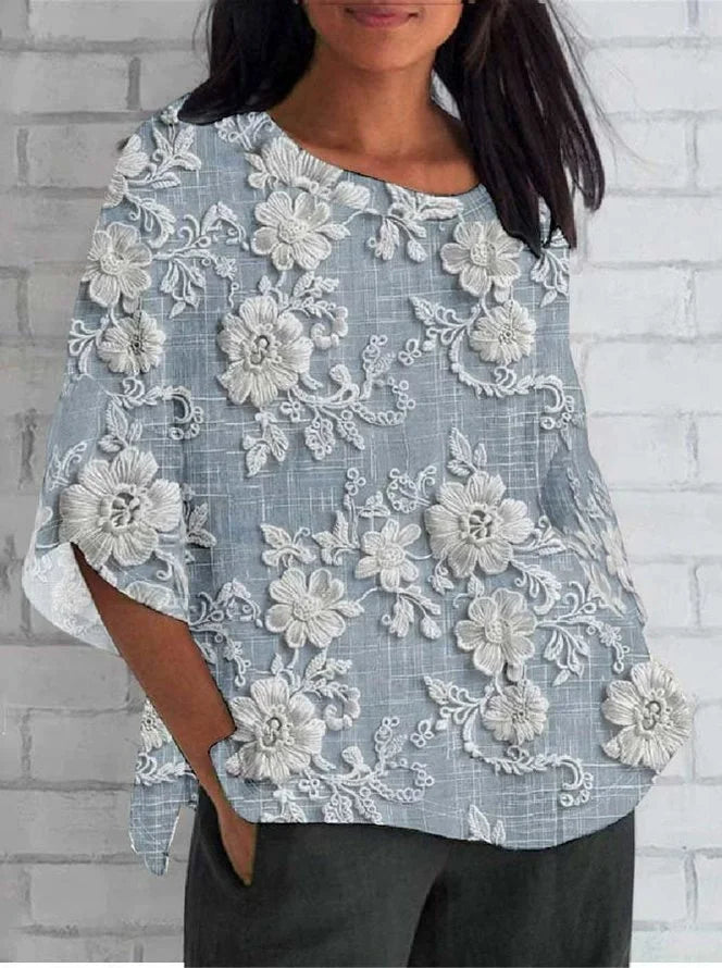  Female modelling a lightweight blouse with delicate floral embroidery.