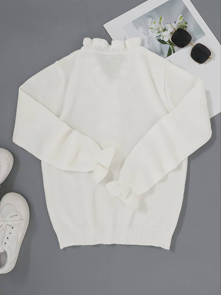 Long sleeve blouse with soft ruffle accents on a plain background.