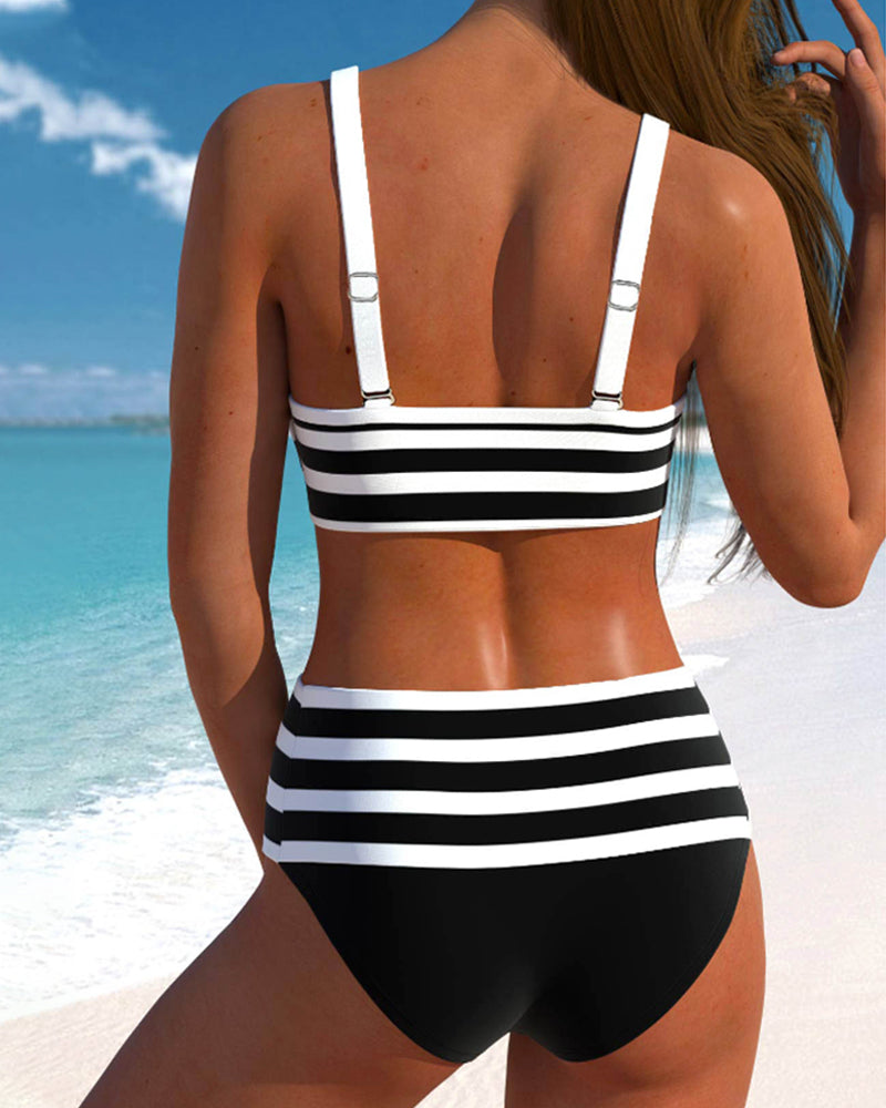Model wearing a printed tankini swim set with relaxed summer styling on a plain background.