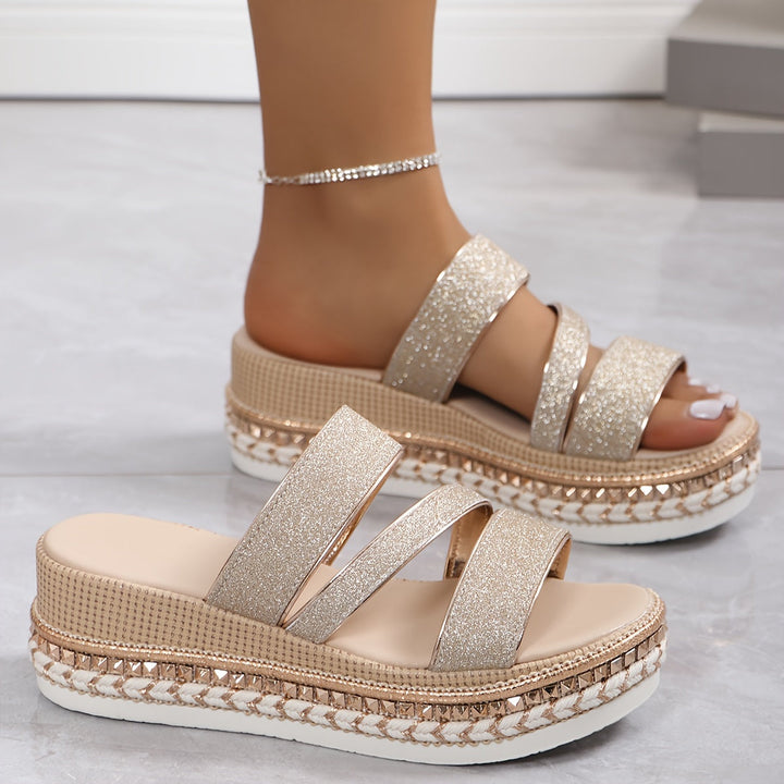 Woman modelling comfortable glitter sandals for warm-weather outfits.