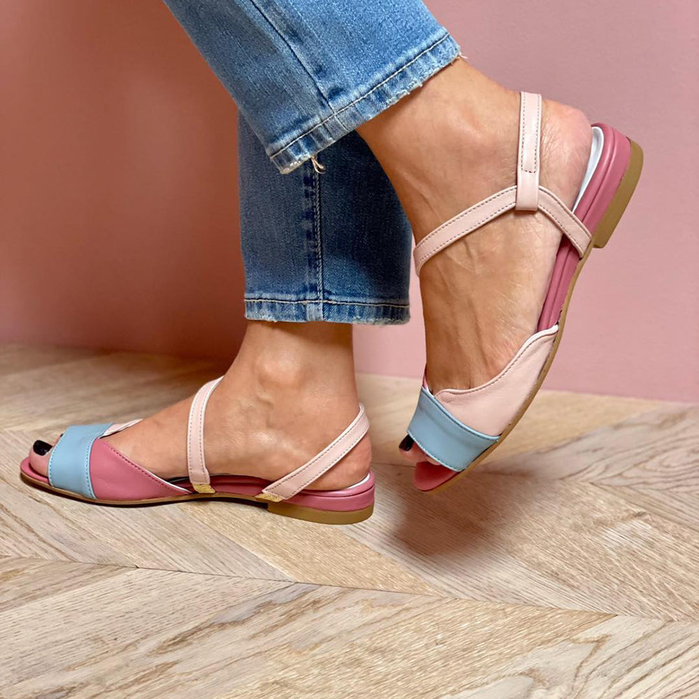 Colourful women’s sandals with open toe design on a plain background.